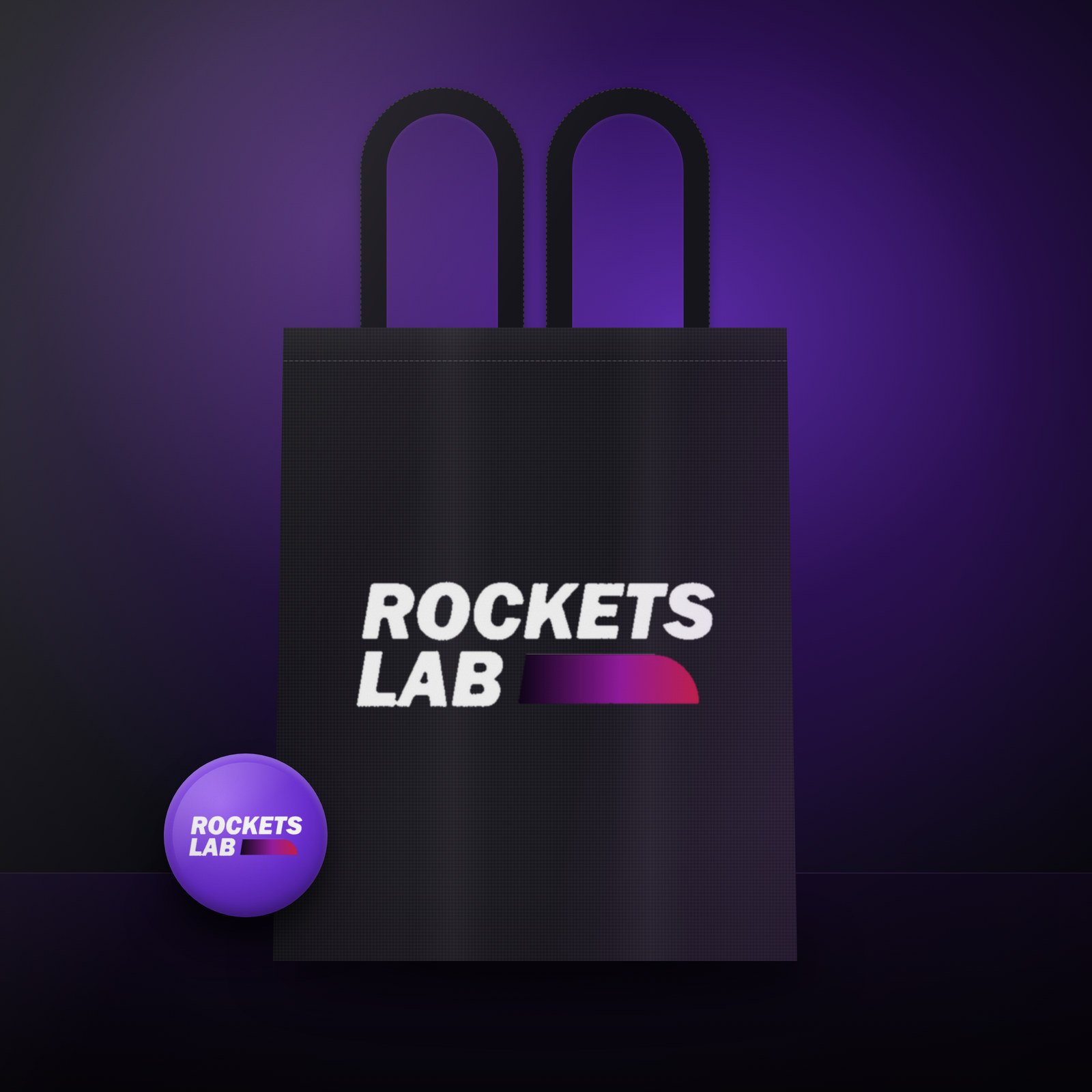 Black tote bag and pin badge carrying the logo